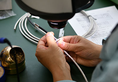 顕微鏡下でケーブル端末を加工する作業